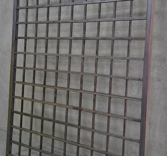 Large custom steel screen panel with a precise grid cutout pattern