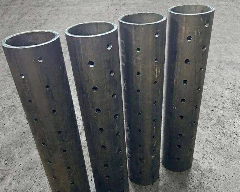 Four upright steel tube sections with precision-drilled hole patterns along their length